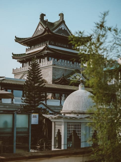 Colorful Lingnan-style building with ornate ridge decorations and carved wooden panels