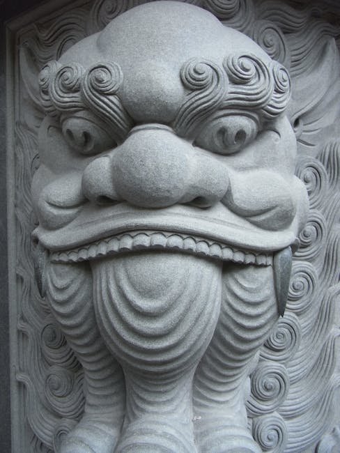 Intricate Chinese architectural wood carving on a traditional building beam and bracket